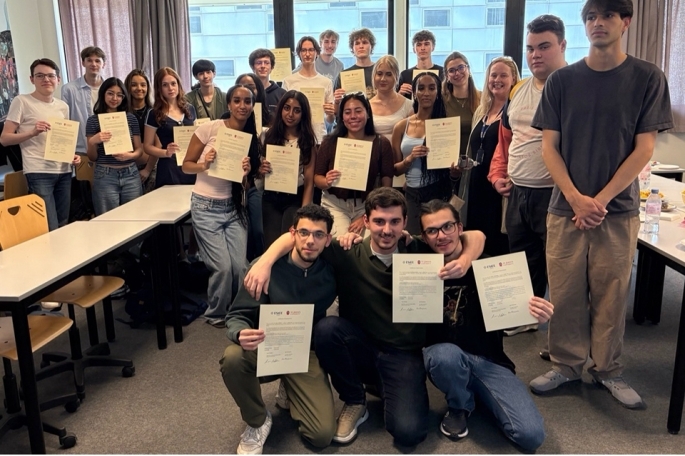 Students holding up papers