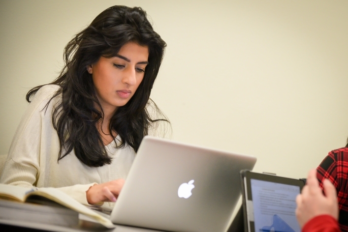 Female student using Mac laptop
