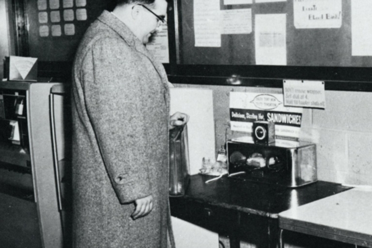 A student toasting a vending machine sandwich in a toaster oven before their next class.