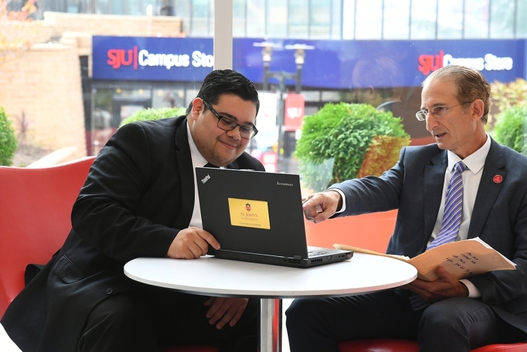 Male faculty member talking to male student