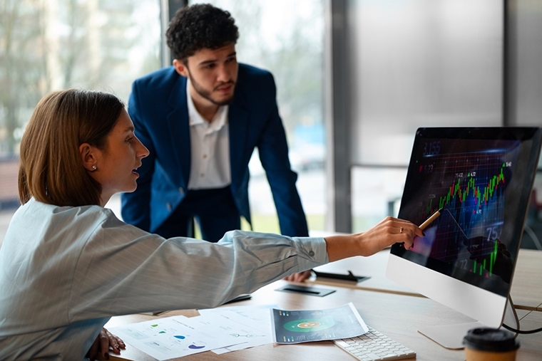 Man and woman looking at computer monitor screen