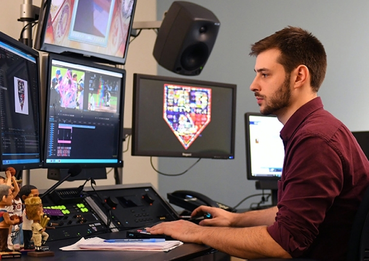 Ryan Gilbert sitting at his desk working on his computer