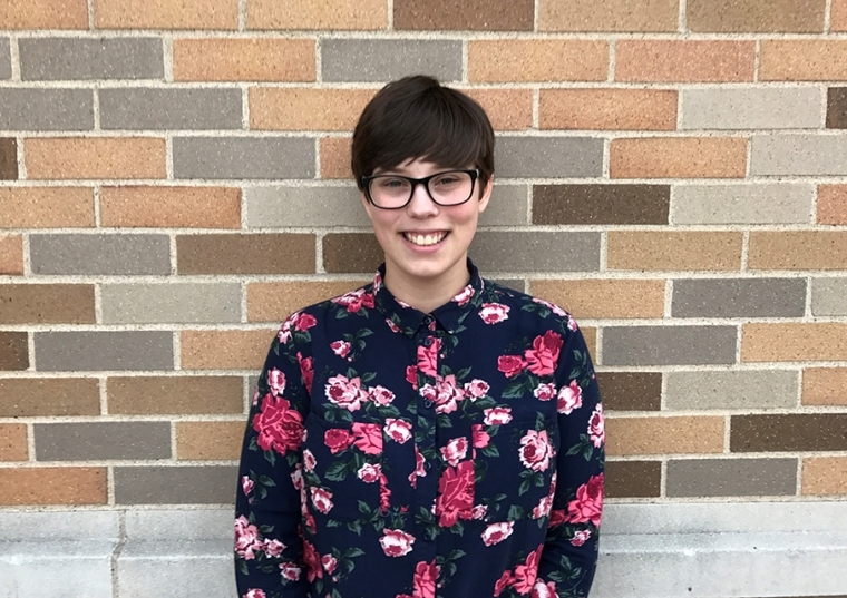 Ashley Hicks in front of a brick wall