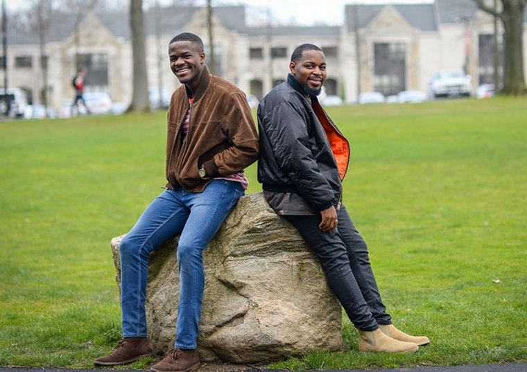 Lang Fonjoe ’17 and Junior Doh ‘17 against a boulder on the Great Lawn