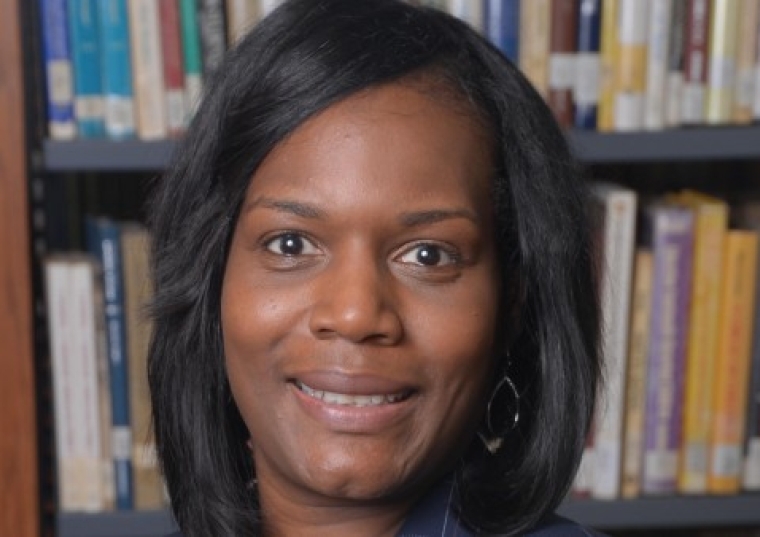 Sandra M. Echols headshot in front of bookshelves