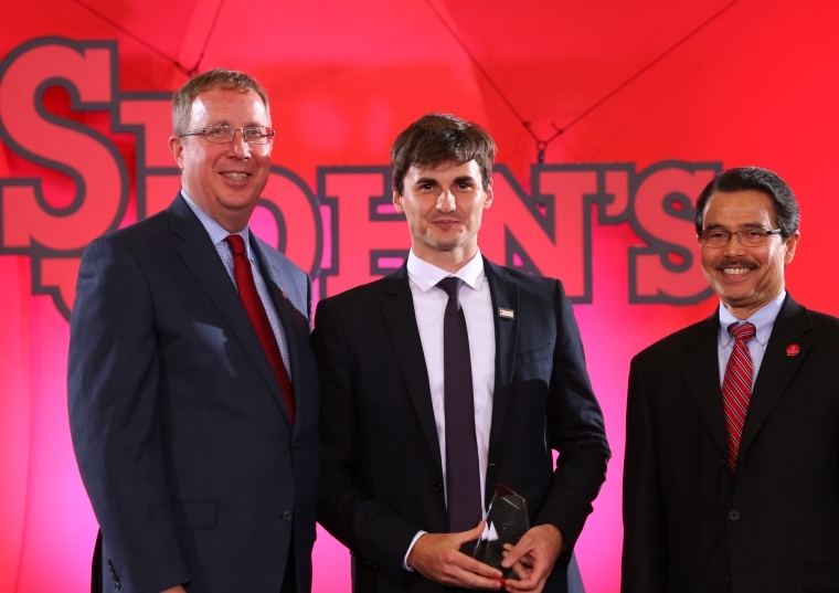 Mike Cragg, Andrei Crapcenco, President Gempesaw posing on stage