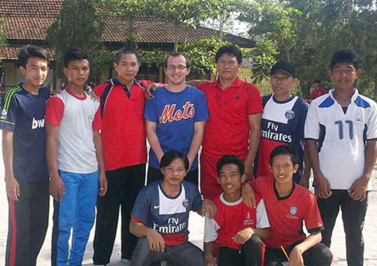 Dylan Kitts poses for picture with group of young men