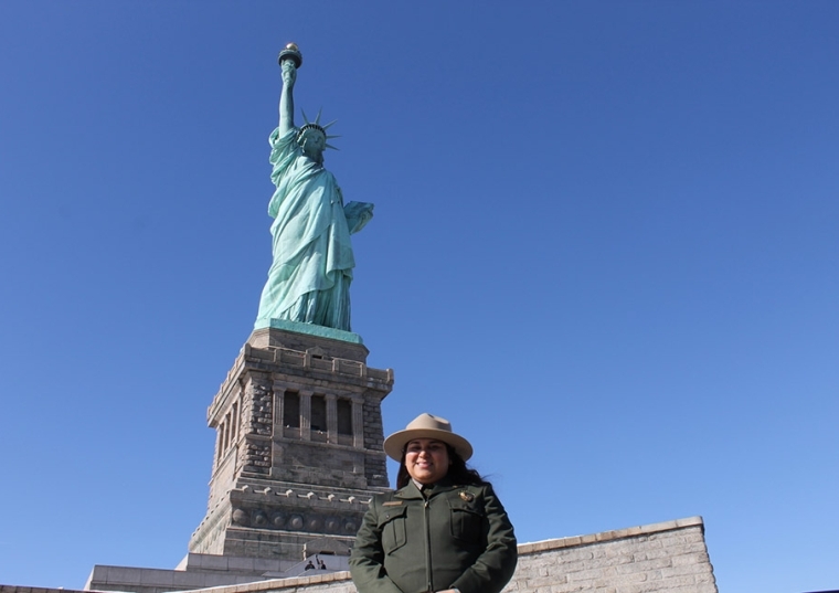 Flor D’Luna (Arellano) Blum in front of the Statue of Liberty