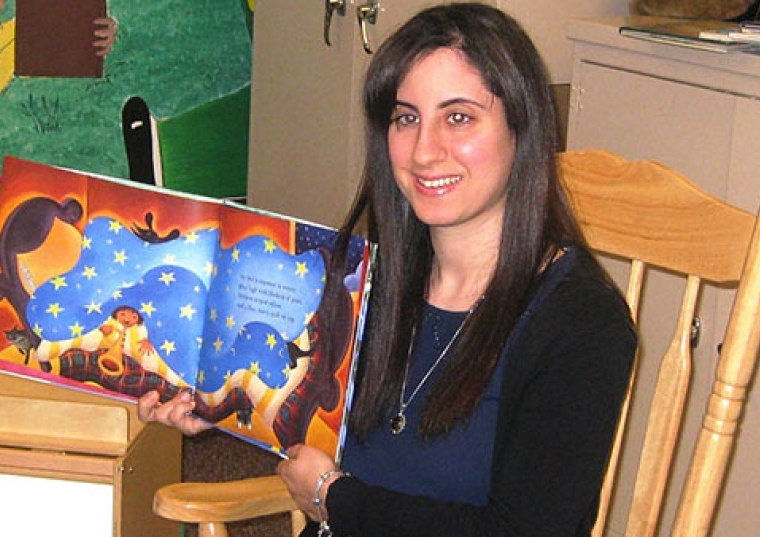 Laura Giunta holding a book open