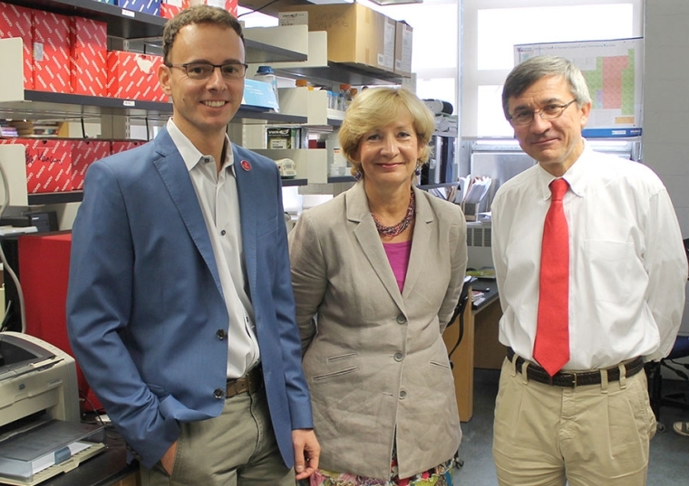 Professors Ruggiu, Vancurova, and Vancura standing in a lab