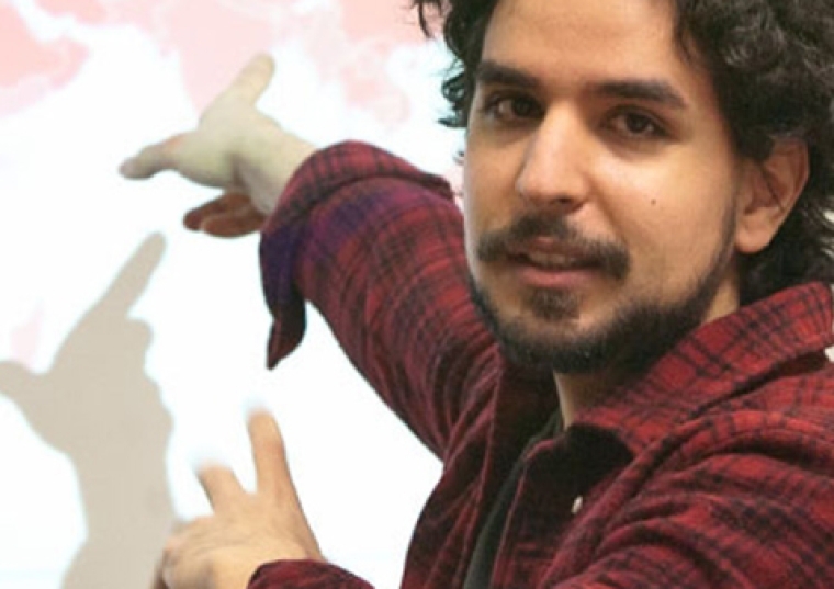 Errol Abaid ‘08CPS pointing at a board