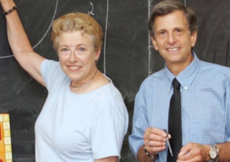Mark and Helen Levy in front of a chalkboard