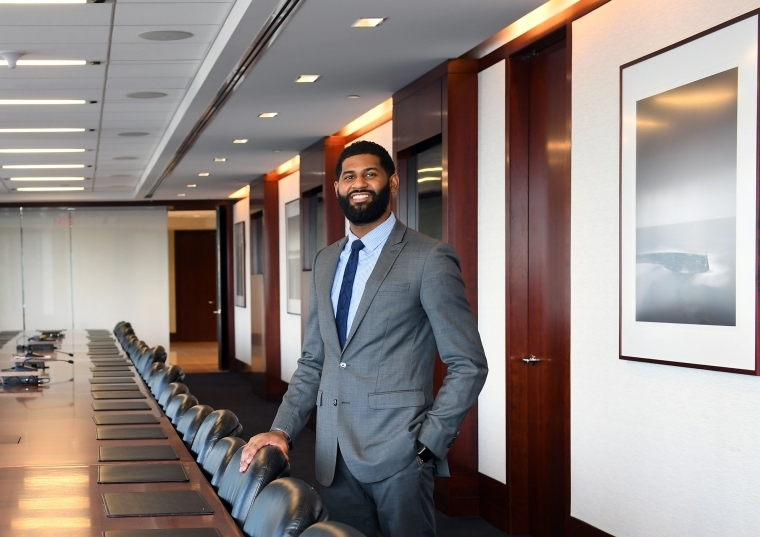 Tahir Boykin in conference room with long wood table and empty chairs