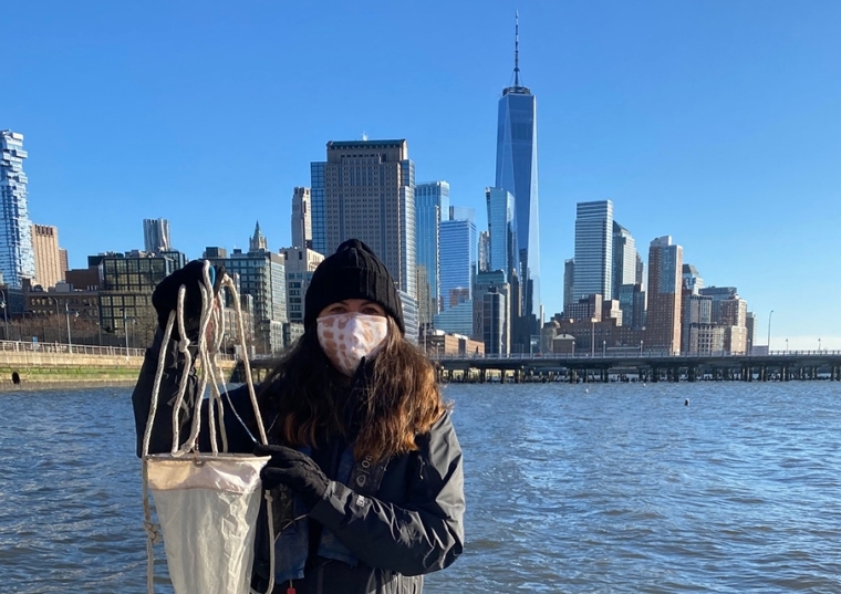 Tina Walsh on a pier with the NYC skyline behind her