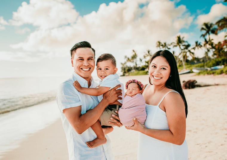 Allie Aoanan-Talavera and her husband with their two kids on the beach