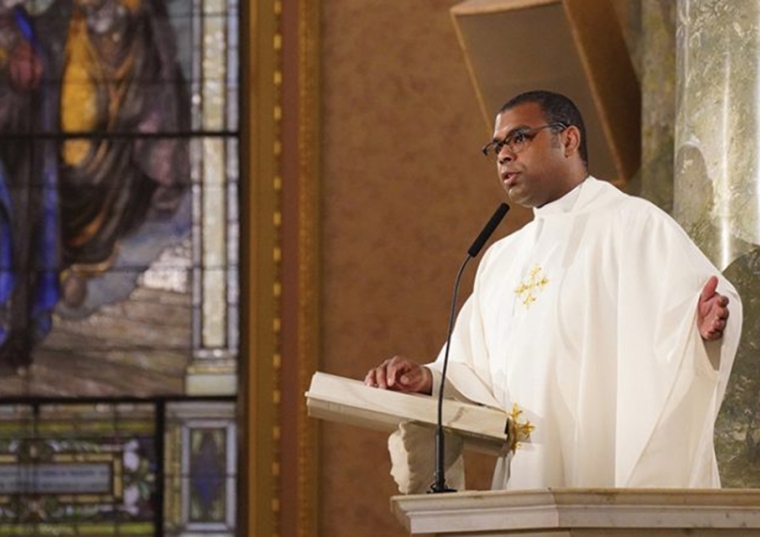 Fr. Alonso Cox reading from bible at mass