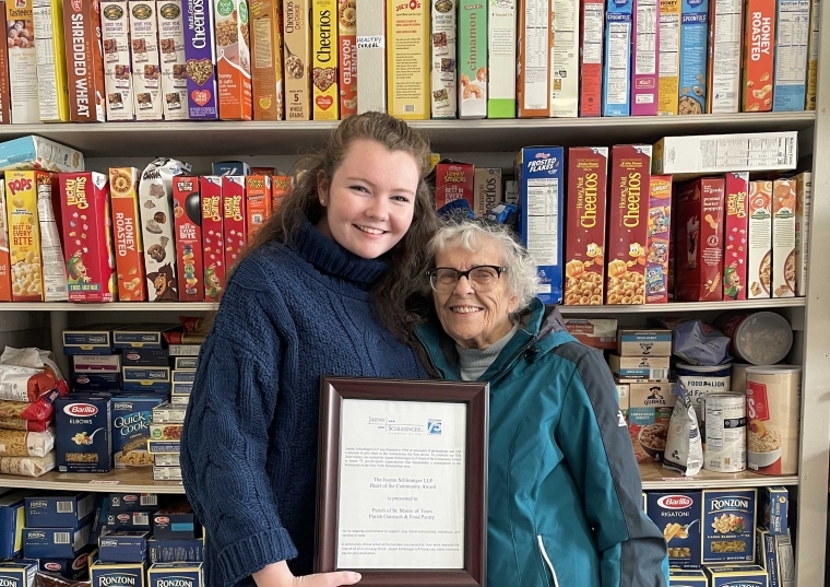 St. John's University Grace Pigott ’19C, ’23GEd holding plaque with another woman