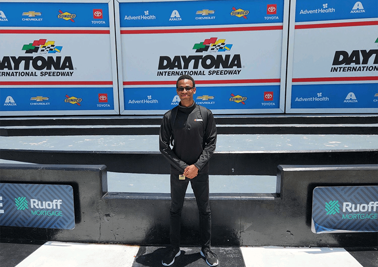 Phillip Hall at NASCAR event posing for a photo