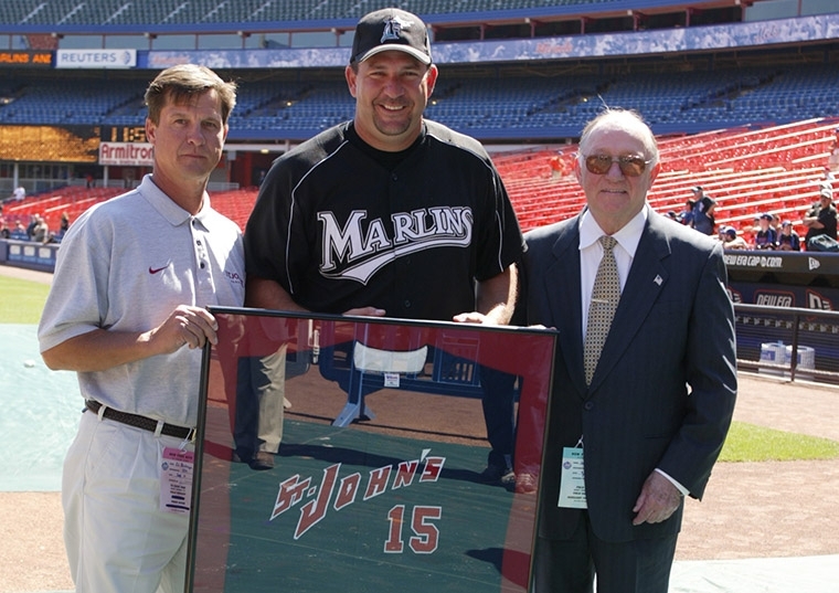 Wayne Rosenthal in his Marlins jersey holding a framed St. John's jersey
