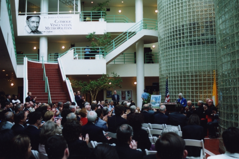 Manhattan Campus Dedication 2001 audience seated in the lobby of 101 Murray Street with a St. John's University banner above the stairs