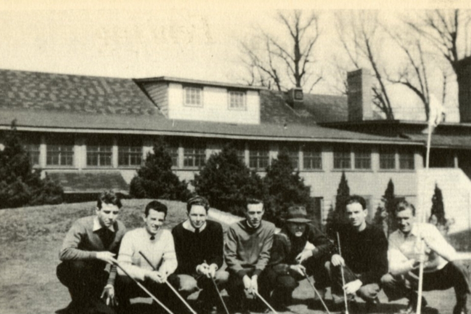A group of St. John's University students playing golf pose in front of the Club House at the Hillcrest Golf Course in 1942.