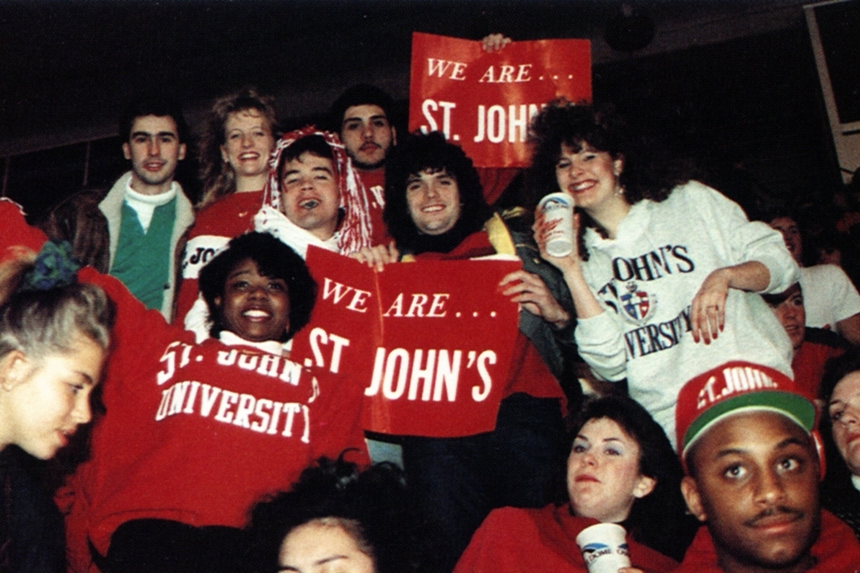 students holding We Are St. John's signs