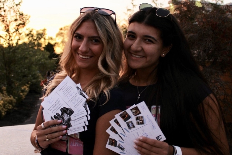 A couple of women holding papers