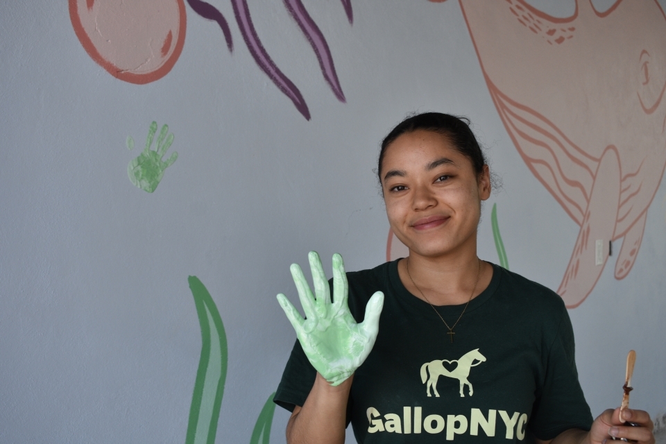 Student painting on a service trip