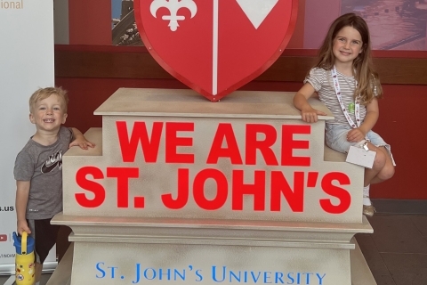 The Bartlett children infront of the St. John's University We Are St. John's statue on the Queens campus