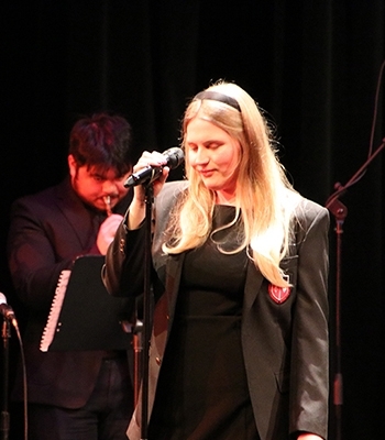 Julianna Vincent singing onstage with jazz band
