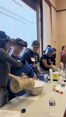 High school students doing experiments at table during St. John's Chemistry Day