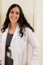 Jennifer Fiebert ’09Pharm.D. in a white lab coat