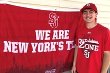 Anthony Romano poses for a picture next to "We Are New York's Team" banner