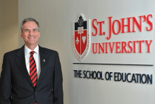 Dean Wolfinger in front of St. John's University The School of Education
