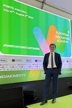 Jonathan Smilovich standing by presentation screen