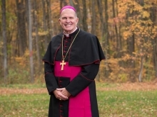 Man standing in front of trees