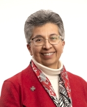 Woman in red jacket facing camera