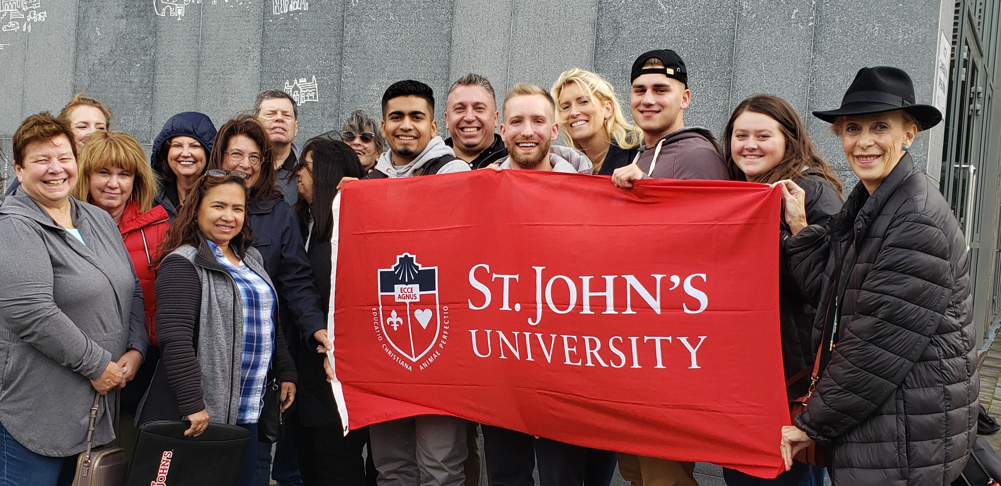 Dr. Licari of CCPS and Dir of Alumni Relations Mark Andrew with SJU students in Limerick