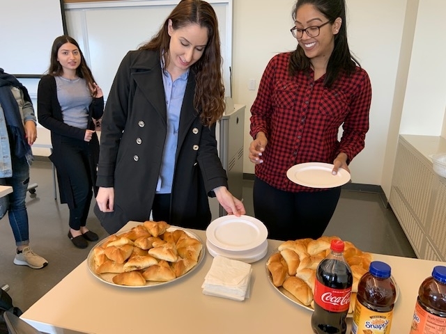 Students enjoying Lebanese pastries at the Arab American Heritage Month celebration.