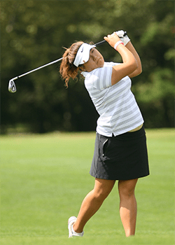 Harin Lee swinging her club on the golf course