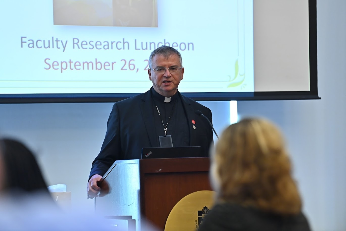 Fr. Griffin Speaking at Podium