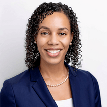 Headshot of Queenie Paniagua wearing a blue blazer.