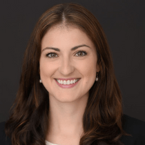 Headshot of Roselind Hallinan with a grey background.