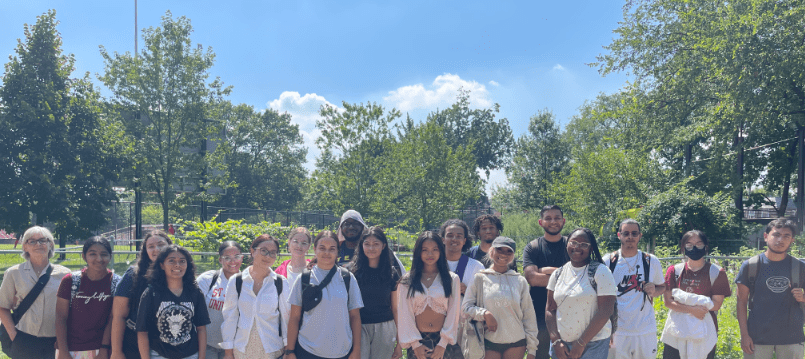 Students pose for a photo in a garden outside