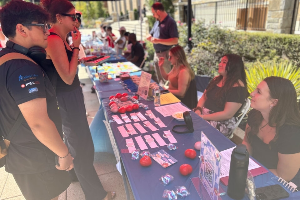 Students visiting table of goodies at Student Wellness Fair