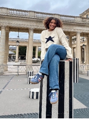 Olivia Padilla sitting on top of a column