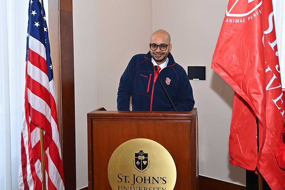 Omar Lopez speaking at podium