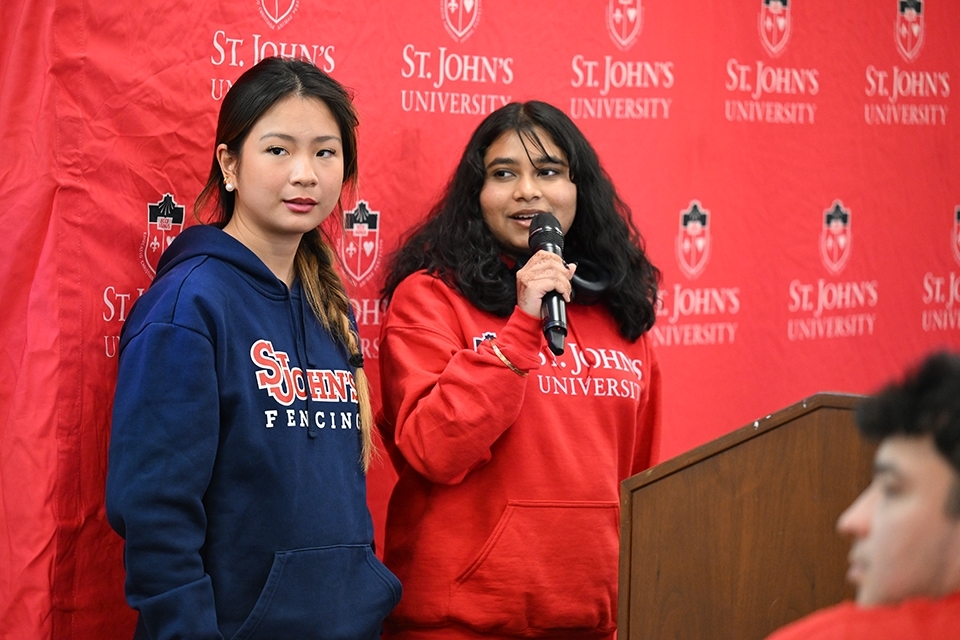 Two high school students presenting at podium