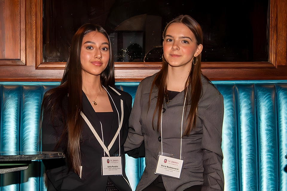Two students sitting on bench.